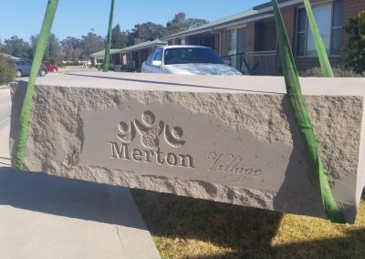 carved sandstone logo sign